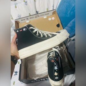 Two pairs of Converse one elevated one regular